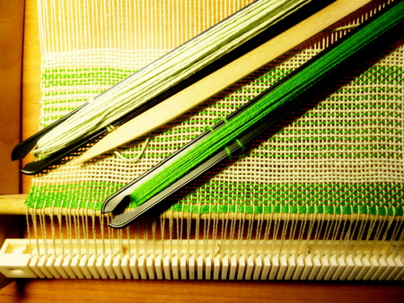 Weaving the fabric in the process. Interlacing of threads. Handwork, handicrafts, craft. Instruments toolsの写真素材