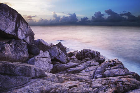 Rocky coast at dusk. Long exposure shot.の写真素材