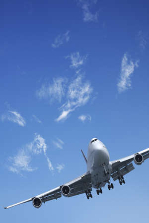 Jet aircraft is maneuvering in a blue sky