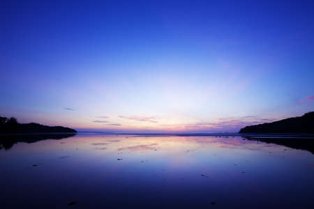 Spectacular sunrise scene at the east coast of Phuket island, Thailand. Long exposure shot.