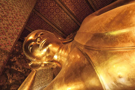 Monument of Reclining Buddha in Wat Pho temple. Bangkok, Thailand.