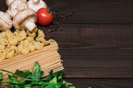 Ingredients, pasta, tomatoes, mushrooms, herbs vegetables and spices Italy wood eat deliciousの写真素材