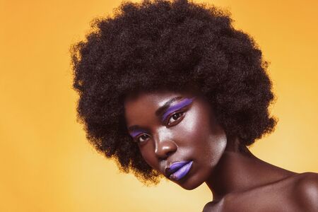 Fashion woman with a short haircut and black skin posing in beauty shotの写真素材