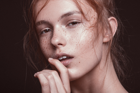 Beauty, woman, female, studio, black background white skin makeup hair hairstyle emotion closeup faceの写真素材