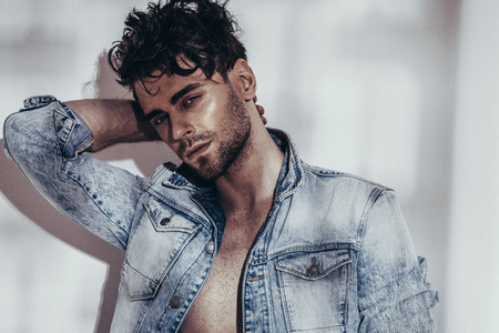 Confident and handsome. Jeans jacket. Looking at camera. Fashion shooting. Hairstyleの写真素材