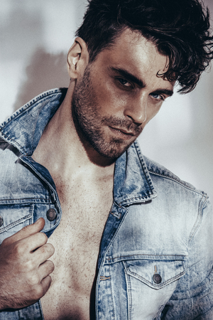 Confident and handsome. Jeans jacket. Looking at camera. Fashion shooting. Hairstyleの写真素材