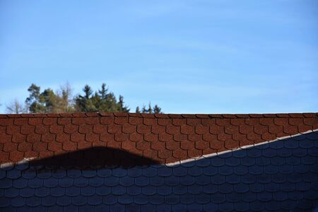 Roof with asphalt shingles is partly frostbitten. Roof.の写真素材