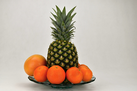 Tropical fruit on a platter, pineapple, mandarin and grapefruit. Fruit.の写真素材