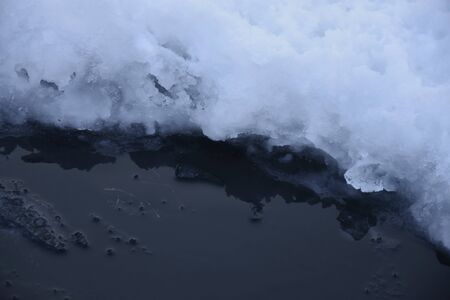 Hole in ice on a pond. Ice.