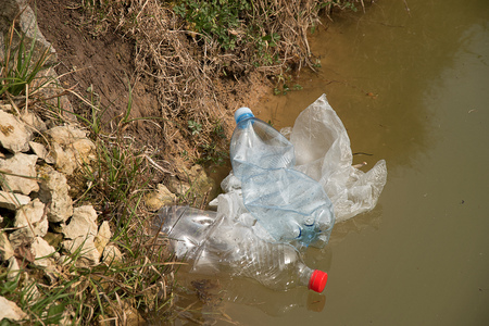 Pollution of plastic in water. Plastic waste floats in water. Environmental Protection. Plastic...