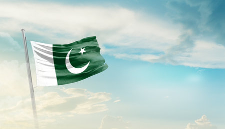 Pakistan flag waving in the wind against blue sky with white clouds 3D illustrationの写真素材