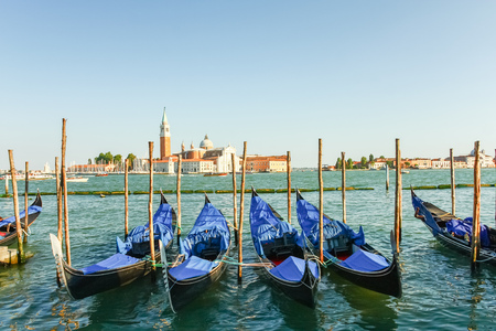 Gondolas moored by Saint Mark square with San Giorgio di Maggiore church in the background, Venice, Italyの写真素材