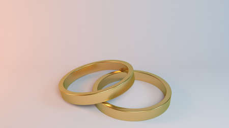 Couple of gold wedding rings on white background inside a 3d stageの写真素材