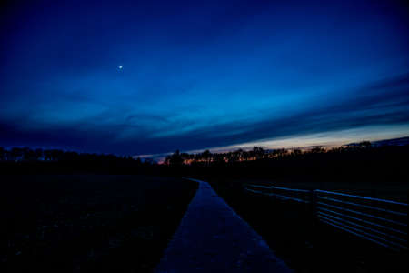 blue sky with moon and open road backgroundの写真素材