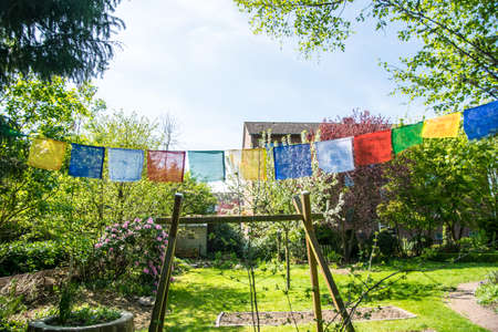 colorful small flags inside an European Garden at spring time