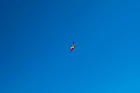 colorful kite in the blue skyの写真素材