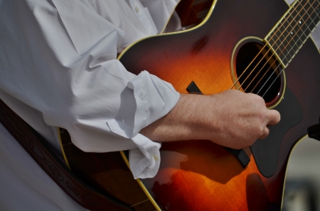 An accomplished musician strumming a guitar の写真素材