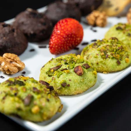 Tasty colorful chocolate cookies on the black backgroundの写真素材