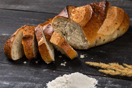 Tasty bread slices with flour and cereal plantの写真素材