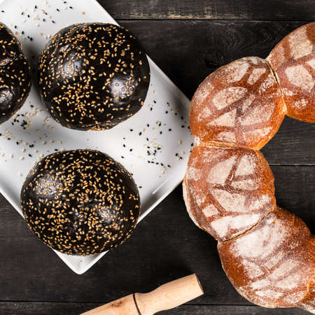 Fresh dark, black and white burger bread, close upの写真素材