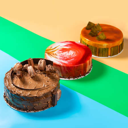 Different beautiful macaron, honey, jam cakes on the colorful backgroundの写真素材