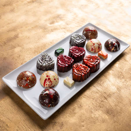 Chocolate pieces on the golden background, top viewの写真素材