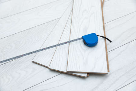 White wood laminate with measuring tape on the floorの写真素材