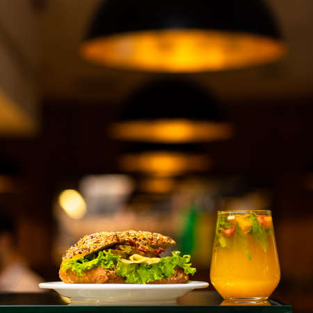 Beef meat sandwich with orange cocktail juiceの写真素材