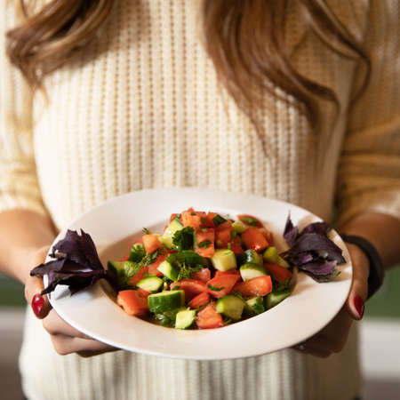 Woman holding beautiful shepherd's saladの写真素材