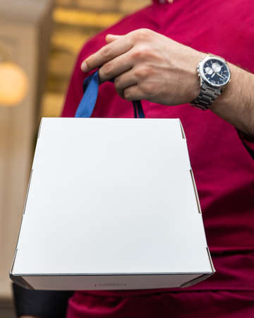 Man holding white boxの写真素材