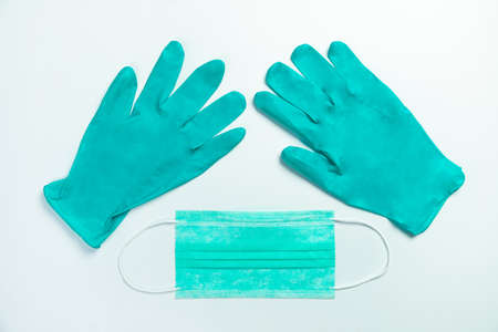 Blue medical protective mask and gloves, top viewの写真素材