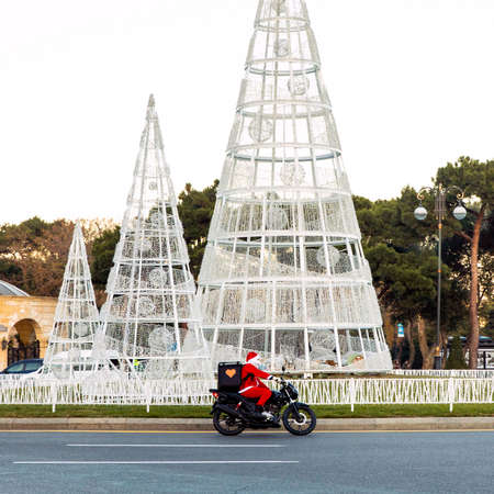 Santa Claus courier driving a motorbikeのeditorial素材