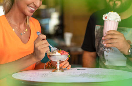 Couple eating ice cream at restaurantのeditorial素材