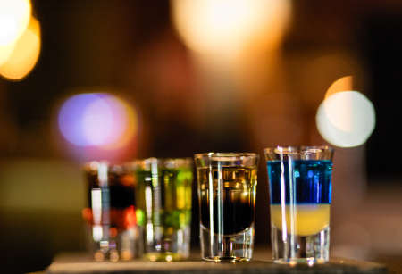 Colorful alcohol vodka cocktails on a bokeh background