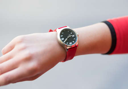 Woman sport style red hand watch close upの写真素材