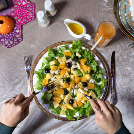Woman eating tasty pumpkin salad top viewの写真素材