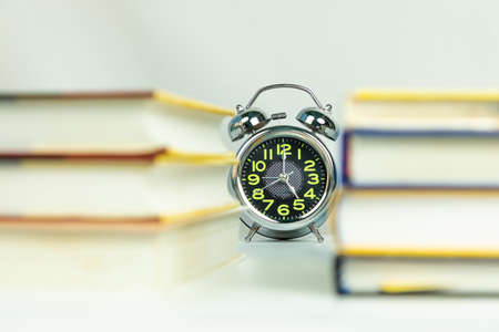 Alarm clock through books, education workspace