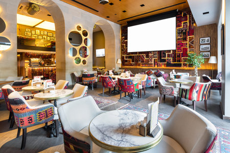 Cozy modern interior of restaurant, teahouse with white projector screen