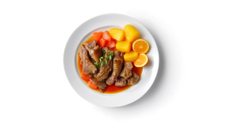Delicious roasted duck with orange sauce, carrots and potatoes garnishing a white plate, isolated on white backgroundの素材