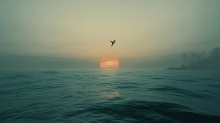 Lone bird flying over calm ocean waves during sunset with distant islandの素材
