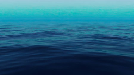 A serene view of the ocean's surface transitioning from deep blue to a lighter turquoise, with subtle waves creating a calming effectの素材