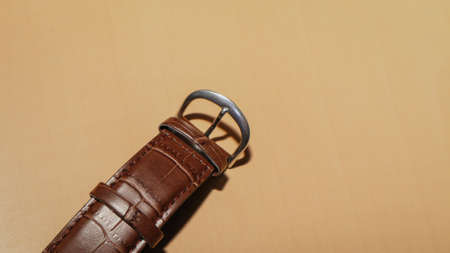 Brown leather watch strap on the office desk