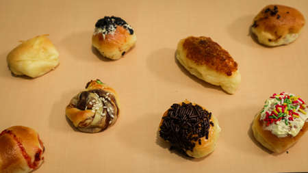 Pastries with various flavors on a wooden tableの写真素材
