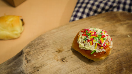 pastries with meises of various colors on a wooden tableの写真素材