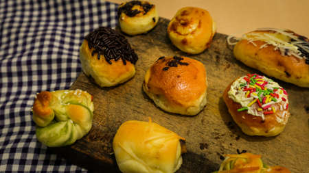 Pastries with various flavors on a wooden tableの写真素材