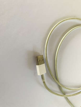 white usb cable that is used to connect between the adapter and the smartphone deviceの写真素材