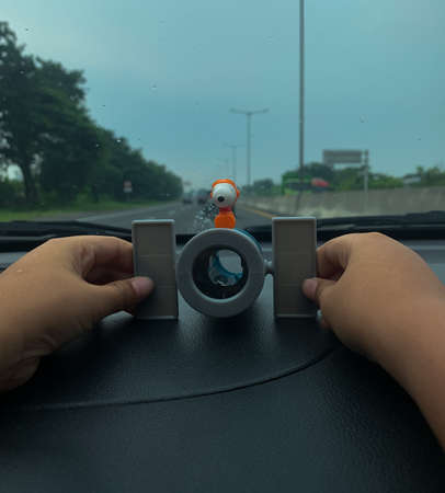 children's toy binoculars on the dashboard of the car