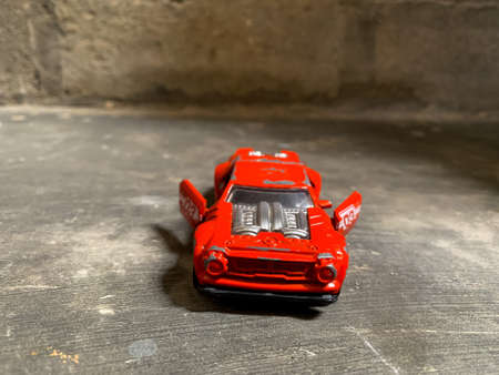 red toy car on a dark gray backgroundの写真素材