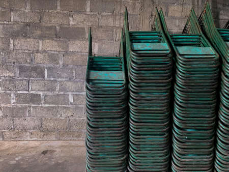 pile of green rusty iron chairsの写真素材