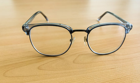 gray glasses on wooden table background